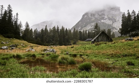 landscape with alpine hut in the mountains on a rainy mood day Gesäuse Austria