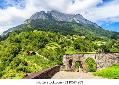 Landscape With Alpine Mountains And Village, Switzerland. Scenery Of Old Houses In Countryside, Scenic View Of Cloudy Mount Top And Rural Terrain. Concept Of Swiss Nature, Weather And Rustic Life.