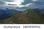 a landscape in the alps under the clouds