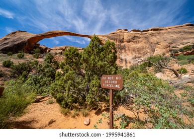 Landscape Arch Along The Devils Garden Trail In Arches National Park Utah, Warning Sign For Hikers Not To Go Beyond The Fence