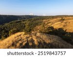 Landscape around Dukovany nuclear power plant. In the foreground, the Mohel steppe and a valley with a water reservoir.