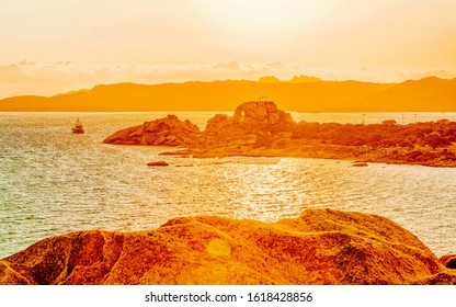 Landscape at Baja Sardinia luxury resort, Costa Smeralda at sunset and evening, Sardegna island in Italy in summer. Scenery in Olbia province. Sunset at Mediteranean sea