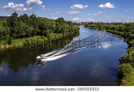 Landscape of banks of the river, speed boat on the river, summer day.View from above.