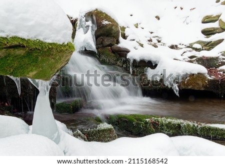 Landscape from Beskydy mountains, mountain creek and waterfall Bystry, Winter forest with waterfall and a lot of white frost snow, freeze water, ice, icicle, winter season in mountains.