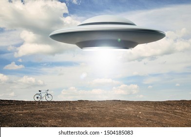 Landscape with bike on the field and UFO. Abduction of people by aliens. Fiction scene with alien spaceship. Photo with 3d rendering element