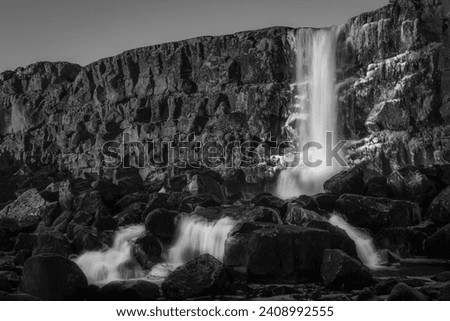 Landscape in black and white of Oxararfoss waterfall in Thingvellir National Park, Iceland. 