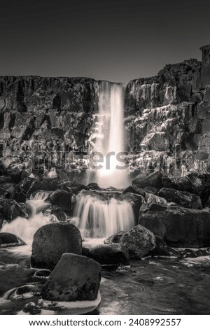 Landscape in black and white of Oxararfoss waterfall in Thingvellir National Park, Iceland. 