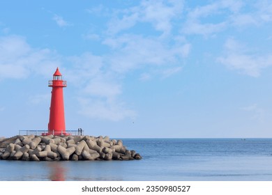 a landscape with a blue sky and a lighthouse - Powered by Shutterstock