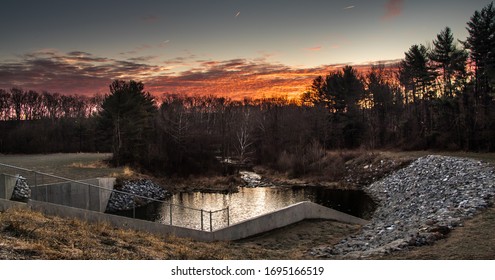 Landscape Of Brightly Colored Clouds And Line Of Trees At  The Spillway Below The Dam At Speedwell Forge Lake