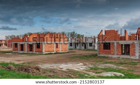 Landscape with buildings in construction. Simple brick houses