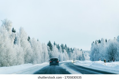 Landscape with a car at the road in snowy winter Lapland, Rovaniemi, Finland