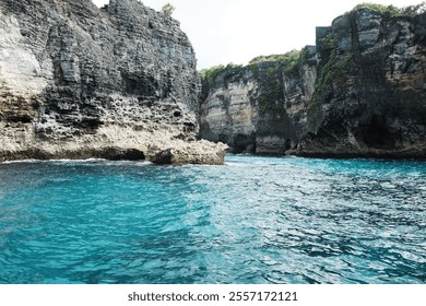 Landscape of cave in rocky cliff at the sea with foam waves and splash water. Travel destination seascape of summer calm ocean in Bali at Indonesia - Powered by Shutterstock