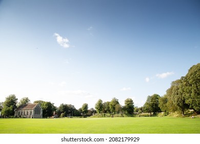 landscape of chichester priory park with the Guildhall building in the background