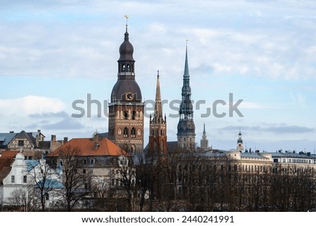 The landscape of the city. Old Town. Riga. A view of church towers in an unusual pivot. Riga Dom, Peterchurch and Anglican Church. Exclusive view. 