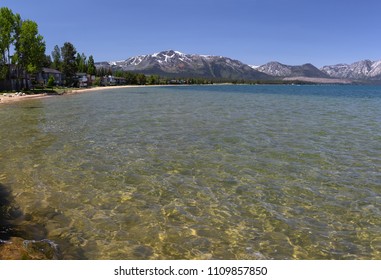 Landscape With Clear Water Of Lake Tahoe, Sandy Beach,homes,trees And Moutains.