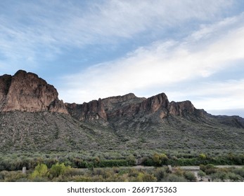 A landscape with cliffs and cloudscape in the background