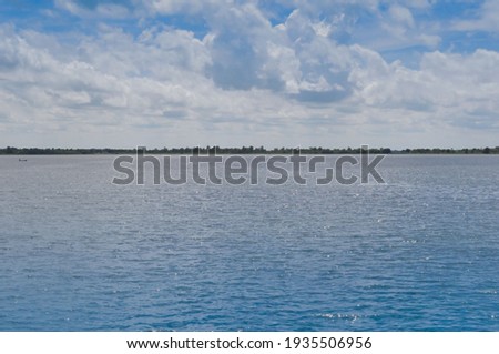 Landscape of cloud and blue sky over reservoir in the summer season  at countryside with water  foreground.