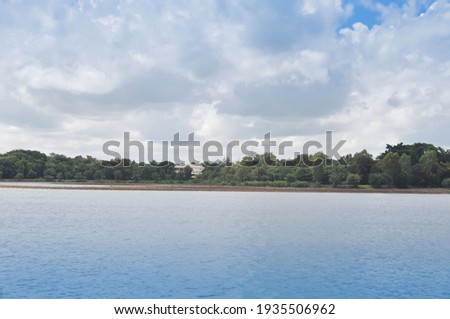 Landscape of cloud and blue sky over reservoir in the summer season  at countryside with water  foreground.