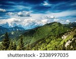 Landscape with cloud shadows over Triglav mountains - view from Golica mountain with green forest - travel summer seasonal concept