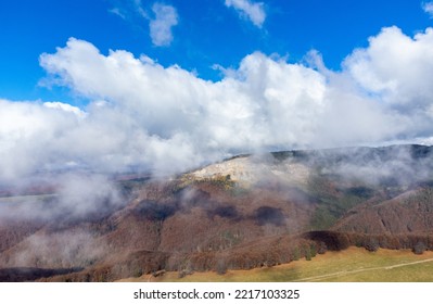 Landscape With Clouds Above Mountains With Withered Forest