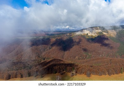 Landscape With Clouds Above Mountains With Withered Forest