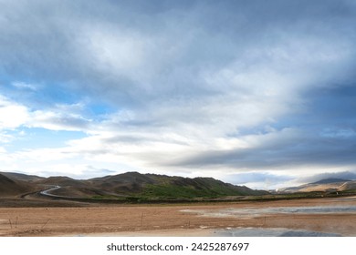 landscape with clouds, red soil wide horizon under the cloudy sky