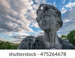 landscape with clouds statue in foreground
