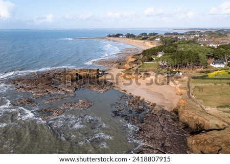 Landscape coastline from drone, coast at low tide in France, rocks, ocean and houses.