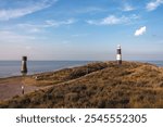 Landscape colour photograph showing Spurn lighthouse and lowlight on a sunny summer