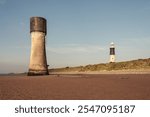 Landscape colour photograph showing Spurn Lowlight and Spurn Lighthouse against a sunny summer sky.