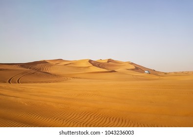 Landscape Of Desert In Dubai, Sand Dunes Which Lack Of Water And Vegetation In Hot Weather Under The Blue Sky In Daylight, And Rapid Temperature Change Between Day And Night When Darkness Revisited.