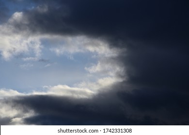Landscape with dramatic clouds against a blue sky.
