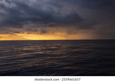 Landscape of an dramatic ocean at sunset with an approaching storm at dusk. Concept of climate change and natural disasters. - Powered by Shutterstock