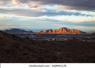 A landscape with dramatic sun light on the mountains. Camelback mountain during sunset. Selectively focused on the mountains.