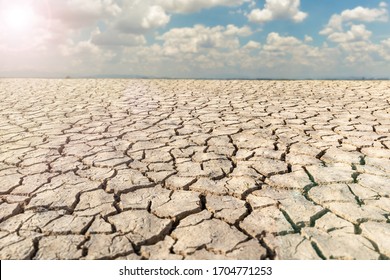 Landscape dried and cracked background. The soil dry land cracked ground surface with sky and cloudy.