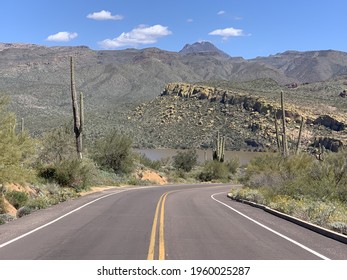 A Landscape Of Empty Asphalt Road To Bartlett Lake Along A Desert Field In Scottsdale, Arizona