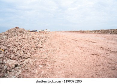 Landscape of empty land plot for industrial development, real estate or housing construction project Reclamation traitor and excavator dump truce car and beautiful blue sky.  Land for sales concept
