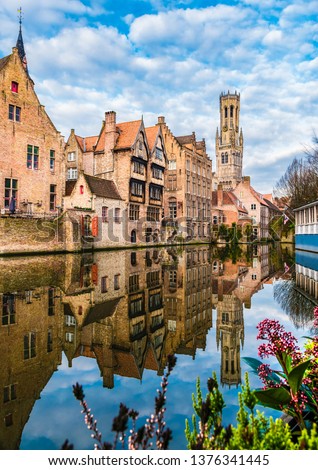 Landscape with famous Belfry tower and medieval buildings along a canal in Bruges, Belgium
