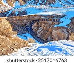 Landscape of the famous Inca bridge in the province of Mendoza in Argentina. It is part of the Inca culture. Day with snow and sun