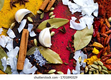 Landscape flat lay of an assortment of spices, flavors and seasonings including garlic, bay leaves, dried chilies and saffron - Powered by Shutterstock