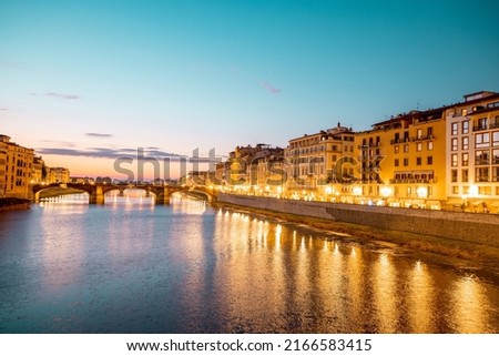 Landscape of Florence old town, night view from the bridge on Arno river and riverside. Beautiful sunset cityscape of Firenze, Italy