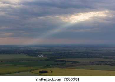 Landscape of forest, fields and two single mountain