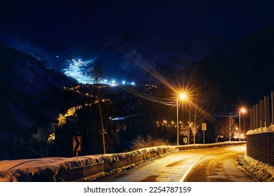 Landscape of glowing road from Medeu ice skate to Shymbulak at Tian Shan mountains at night time in Almaty city, Kazakhstan - Shutterstock ID 2254787159