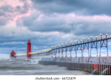 Landscape of the Grand Haven, Michigan Lighthouse at dawn with surf flowing over pier, Lake Michigan, USA