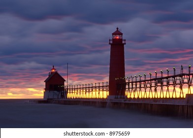 Landscape of the Grand Haven, Michigan Lighthouse, pier, and catwalk at sunset, Lake Michigan, USA