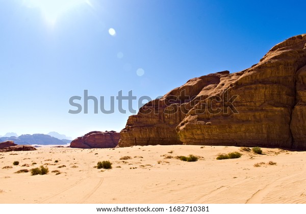 Landscape. Grand open\
desert view, the tire track in the fore ground. Created in Wadi\
Rum, Jordan,\
12/22/2019