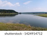 Landscape of grass, lake and hill at Yellowstone National Park in Wyoming                            