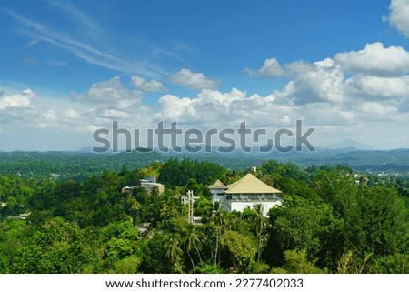 Landscape of green hills and cloudy blue sky