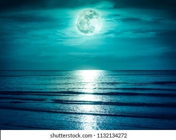 Landscape Of Green Sky With Dark Cloudy And Bright Full Moon Over Seascape In The Evening. Serenity Nature Background, Outdoor At Nighttime. The Moon Taken With My Own Camera.