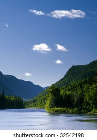 landscape with high mountain and river in a valley from Quebec Reserve Parc de la Jacques Cartier.